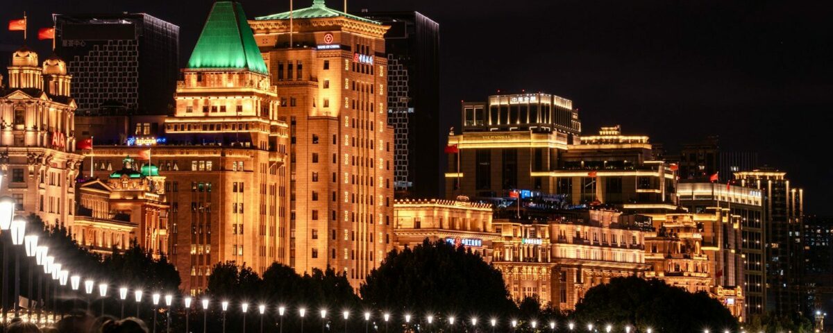 A group of people sitting on a bench in front of a city
