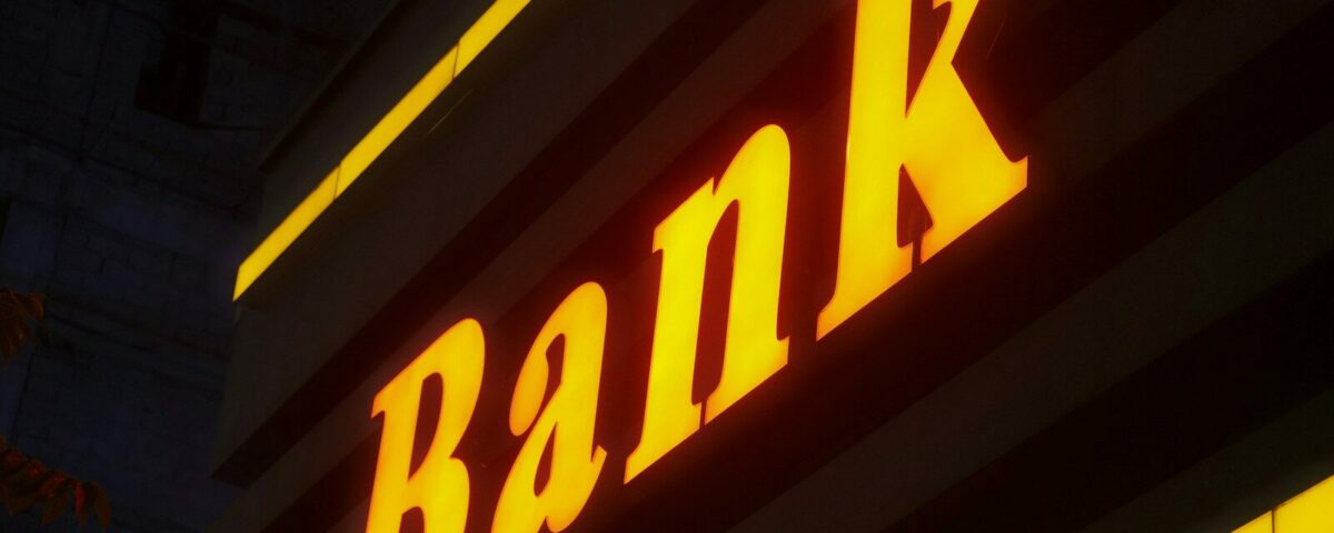 a bank sign lit up in the dark