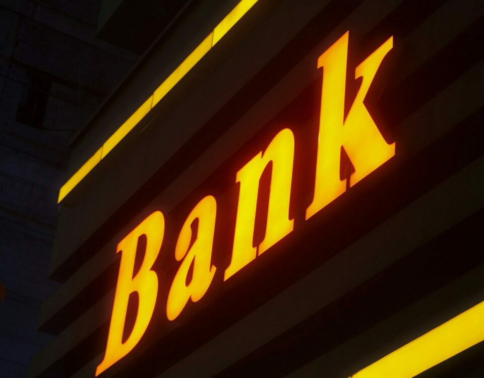 a bank sign lit up in the dark